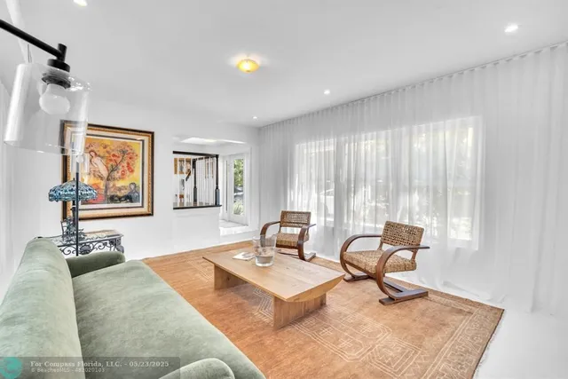 a bedroom with a bed and a table with potted plants
