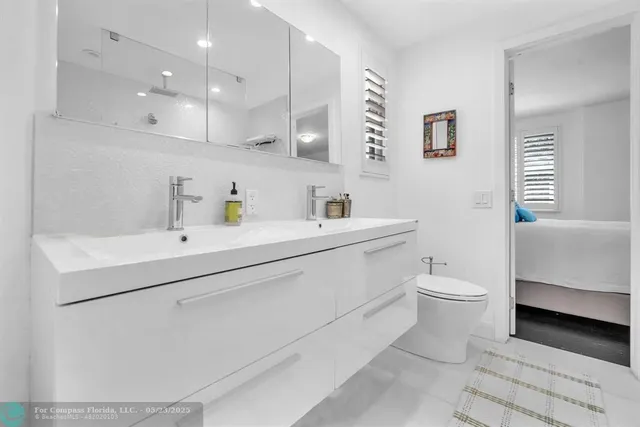 a view of a dining room kitchen with furniture and chandelier
