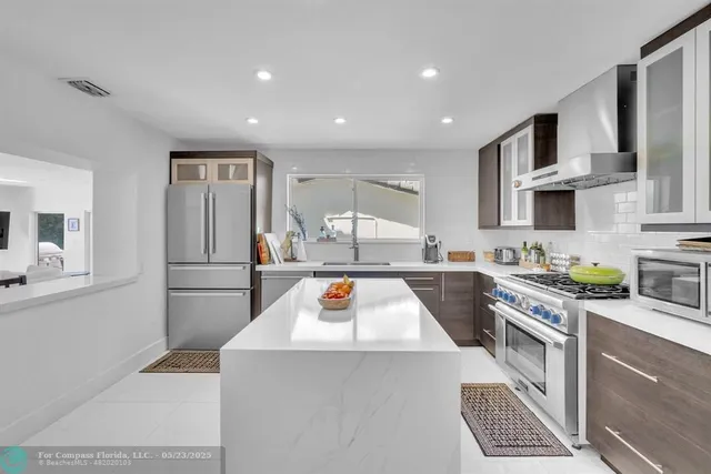 a view of a dining room with furniture and a large window
