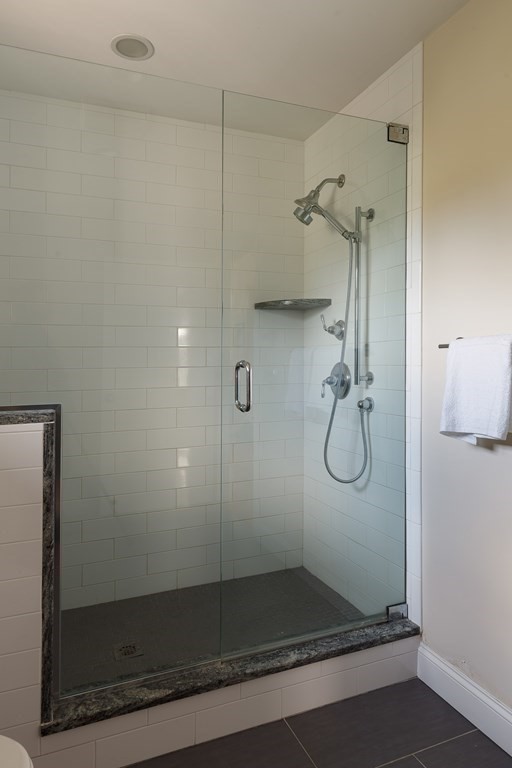 79 Bay State Road Arlington, MA 02474 - Photo 13 of 31 a bathroom with a glass shower door