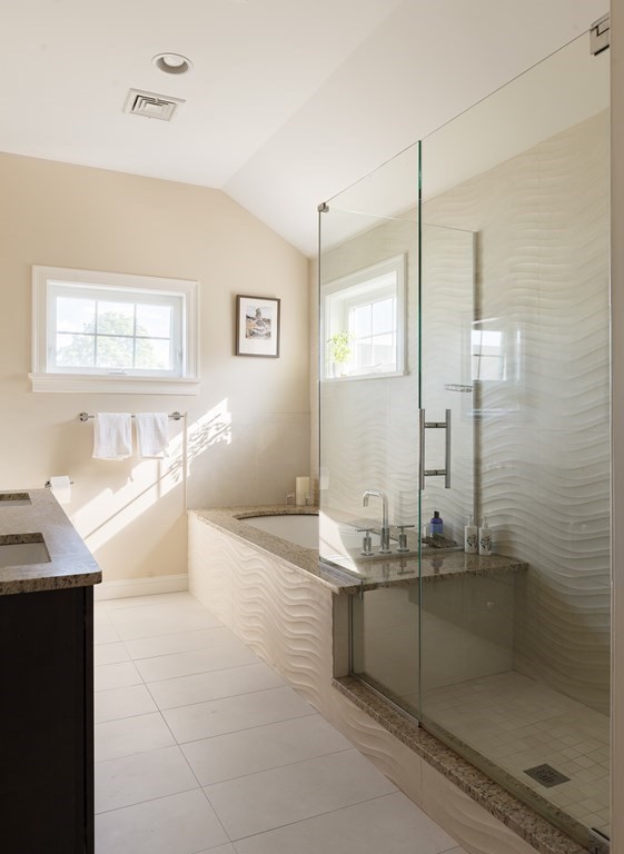 79 Bay State Road Arlington, MA 02474 - Photo 18 of 31 a bathroom with a granite countertop sink a mirror and a bathtub