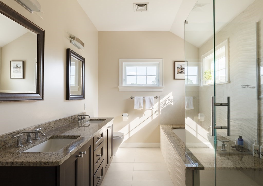 79 Bay State Road Arlington, MA 02474 - Photo 19 of 31 a bathroom with a granite countertop sink a mirror and a shower