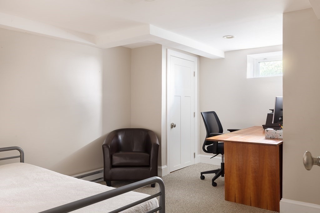 79 Bay State Road Arlington, MA 02474 - Photo 25 of 31 a room with a chair and a window