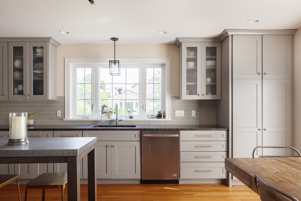 79 Bay State Road Arlington, MA 02474 - Photo 4 of 31 a kitchen with a sink stove and cabinets
