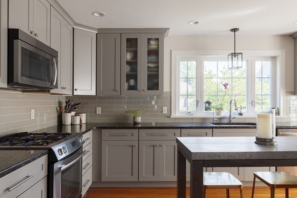 79 Bay State Road Arlington, MA 02474 - Photo 6 of 31 a kitchen with granite countertop cabinets stainless steel appliances and window