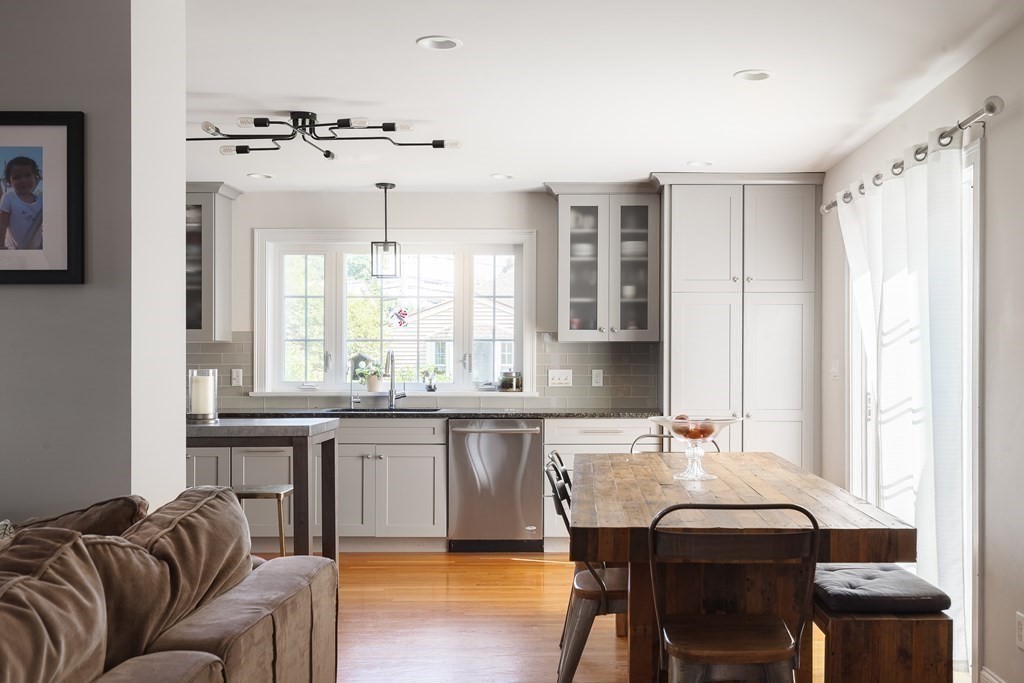79 Bay State Road Arlington, MA 02474 - Photo 7 of 31 a kitchen with granite countertop a table and chairs in it
