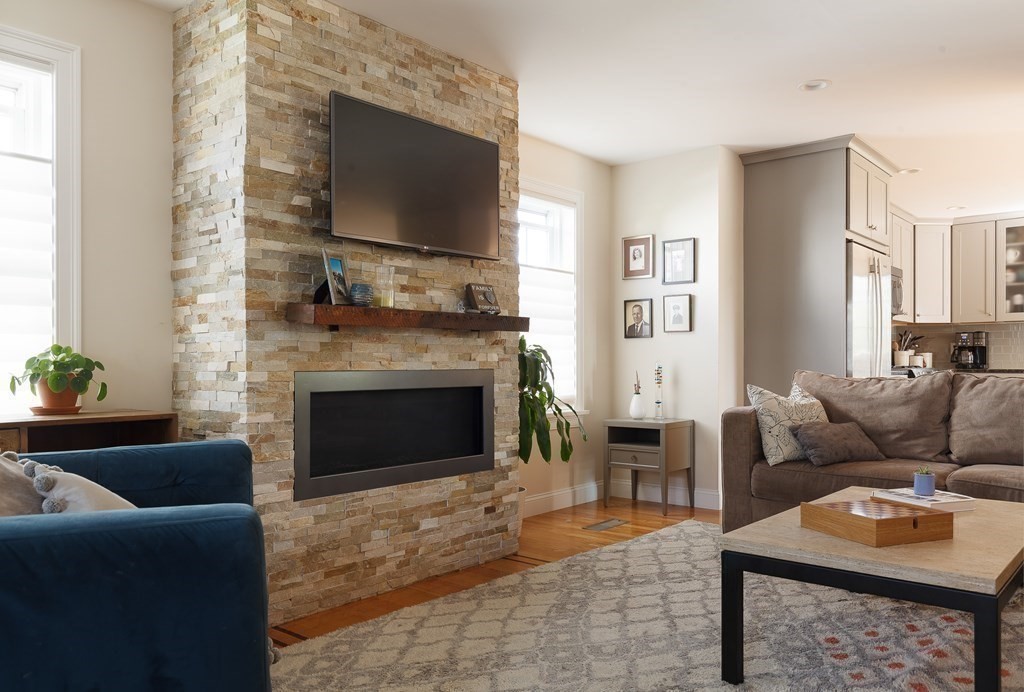 79 Bay State Road Arlington, MA 02474 - Photo 8 of 31 a living room with furniture and a fireplace