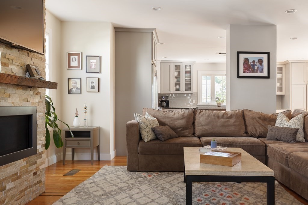 79 Bay State Road Arlington, MA 02474 - Photo 10 of 31 a living room with furniture a fireplace and a table
