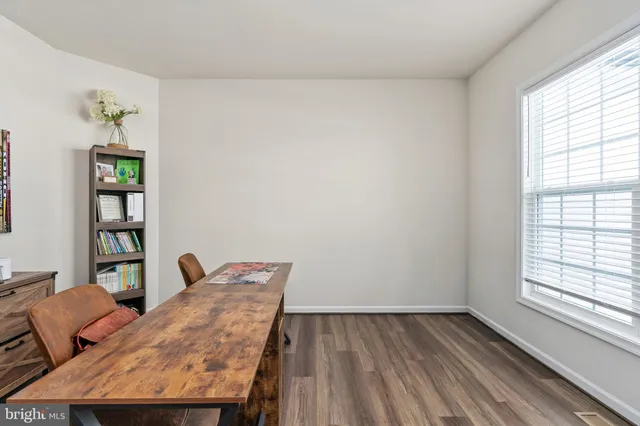 a dining room with furniture a chandelier and wooden floor