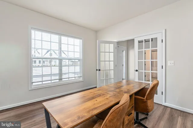 a kitchen with granite countertop a sink a counter top space and living room view