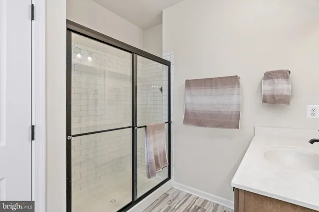 a view of a house with large space and a car parked in front of it