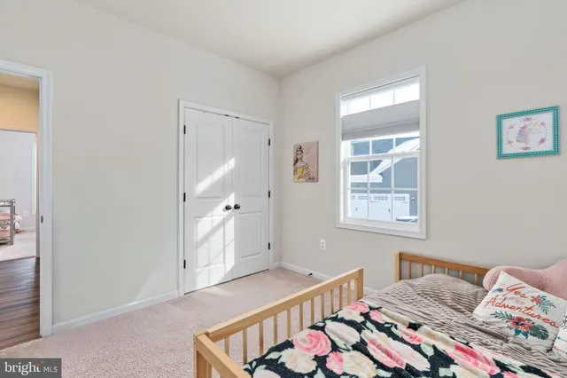 a view of a street with a building and trees in the background