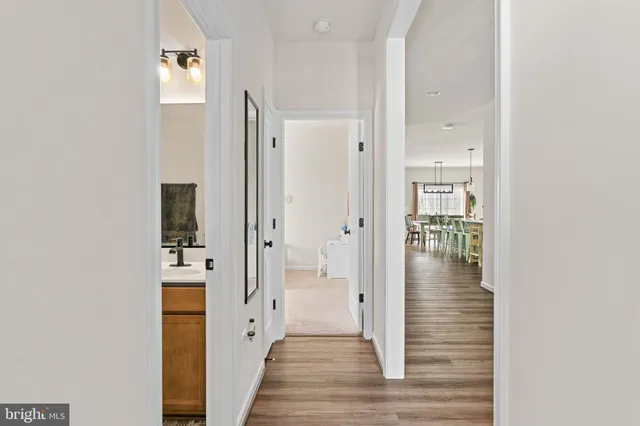 a kitchen with granite countertop white cabinets and stainless steel appliances