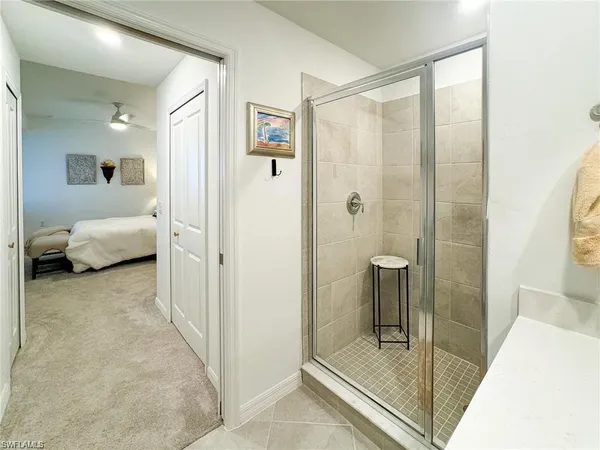 a en suite bathroom with a shower and a sink