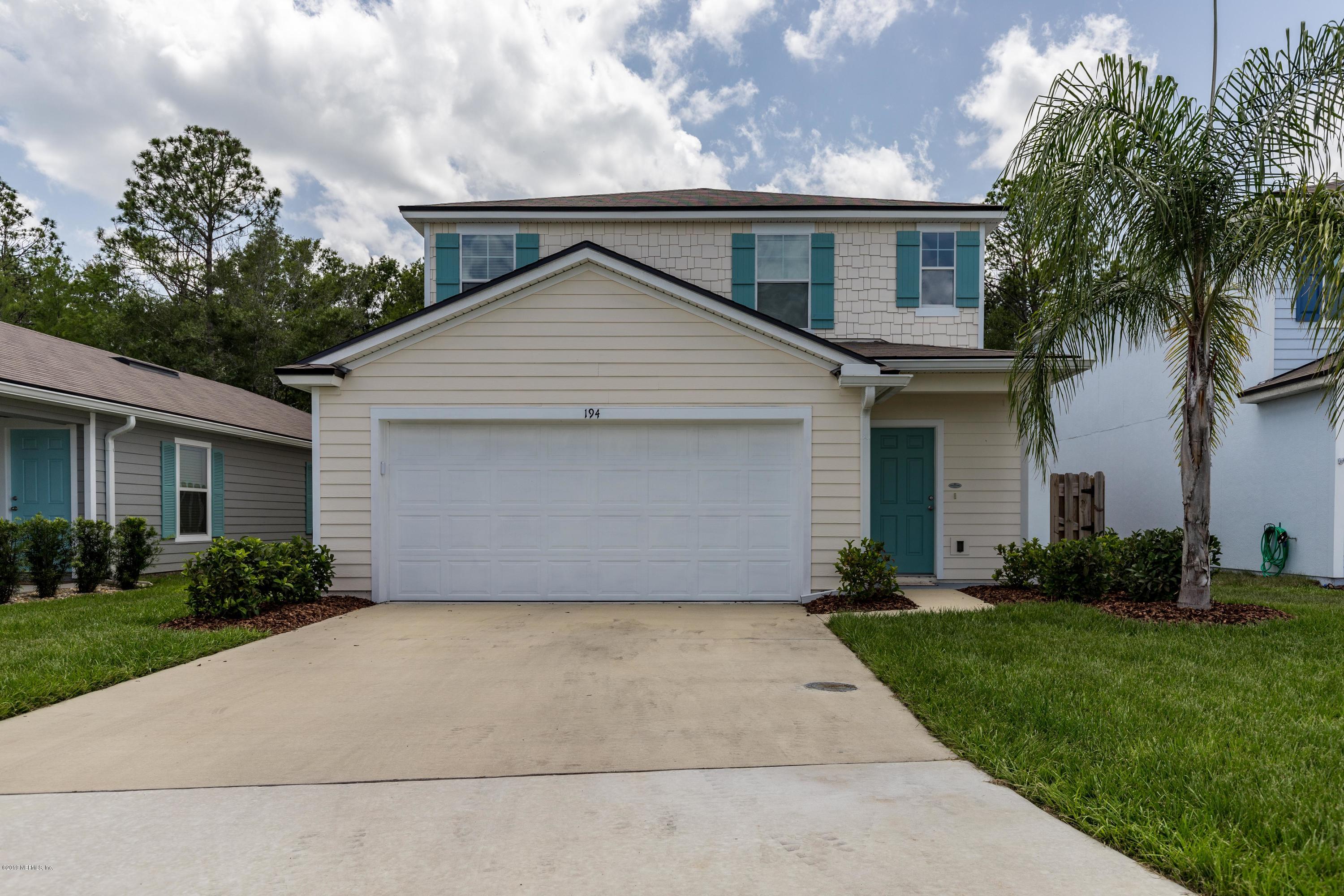 a front view of house with yard and trees