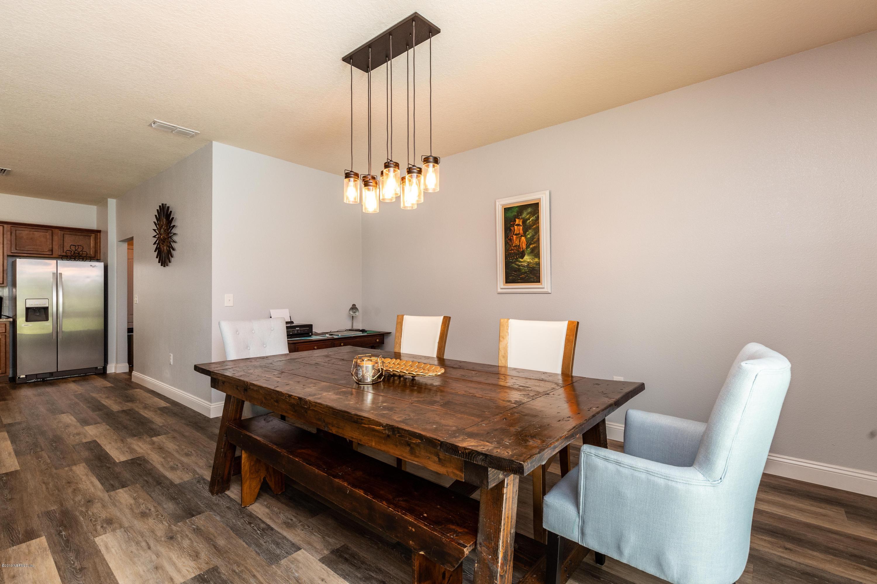 194 Ashby Landing Way St. Augustine, FL 32086 - Photo 13 of 41 a view of a dining room with furniture and wooden floor