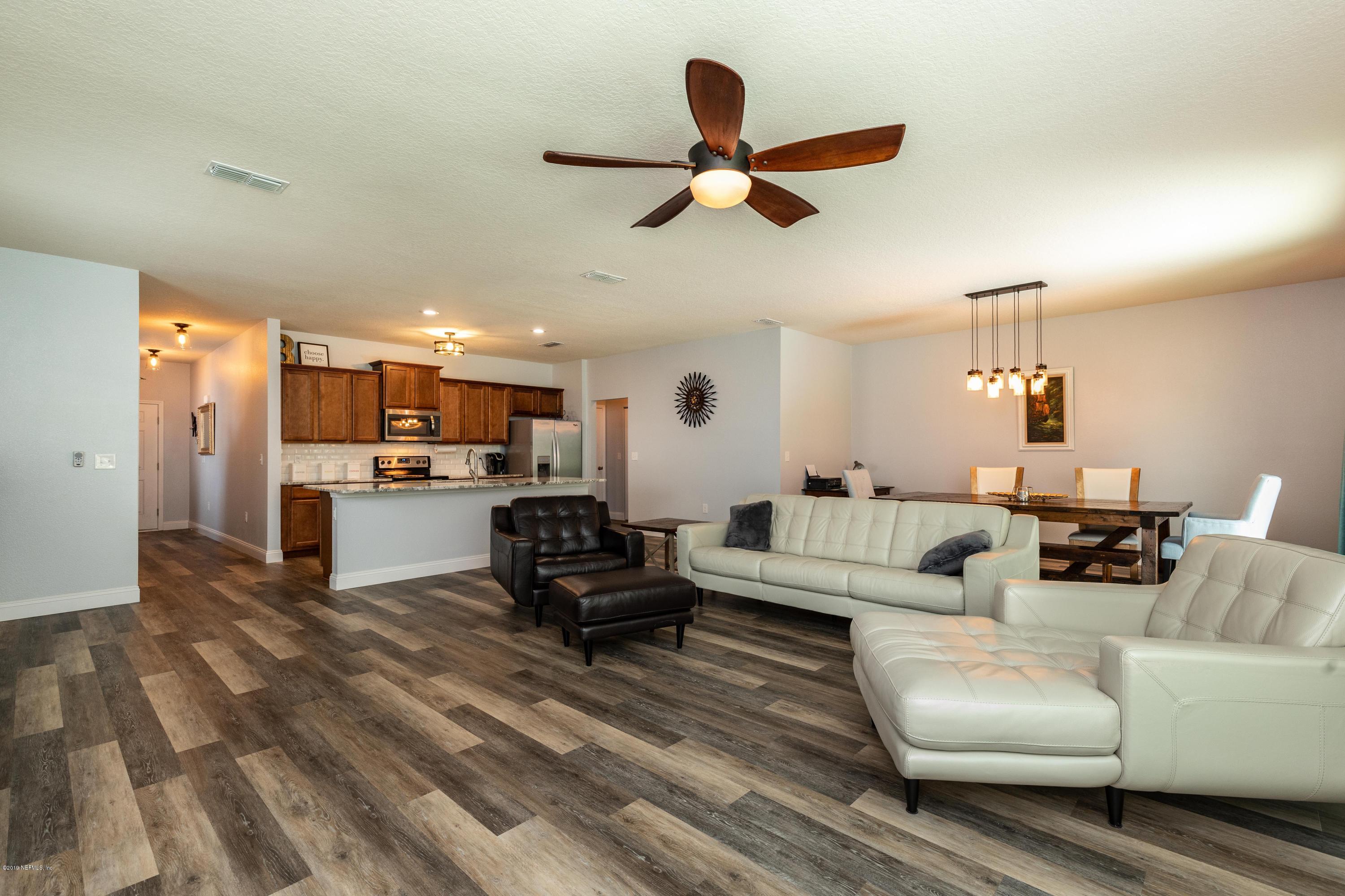 194 Ashby Landing Way St. Augustine, FL 32086 - Photo 18 of 41 a living room with furniture and kitchen view