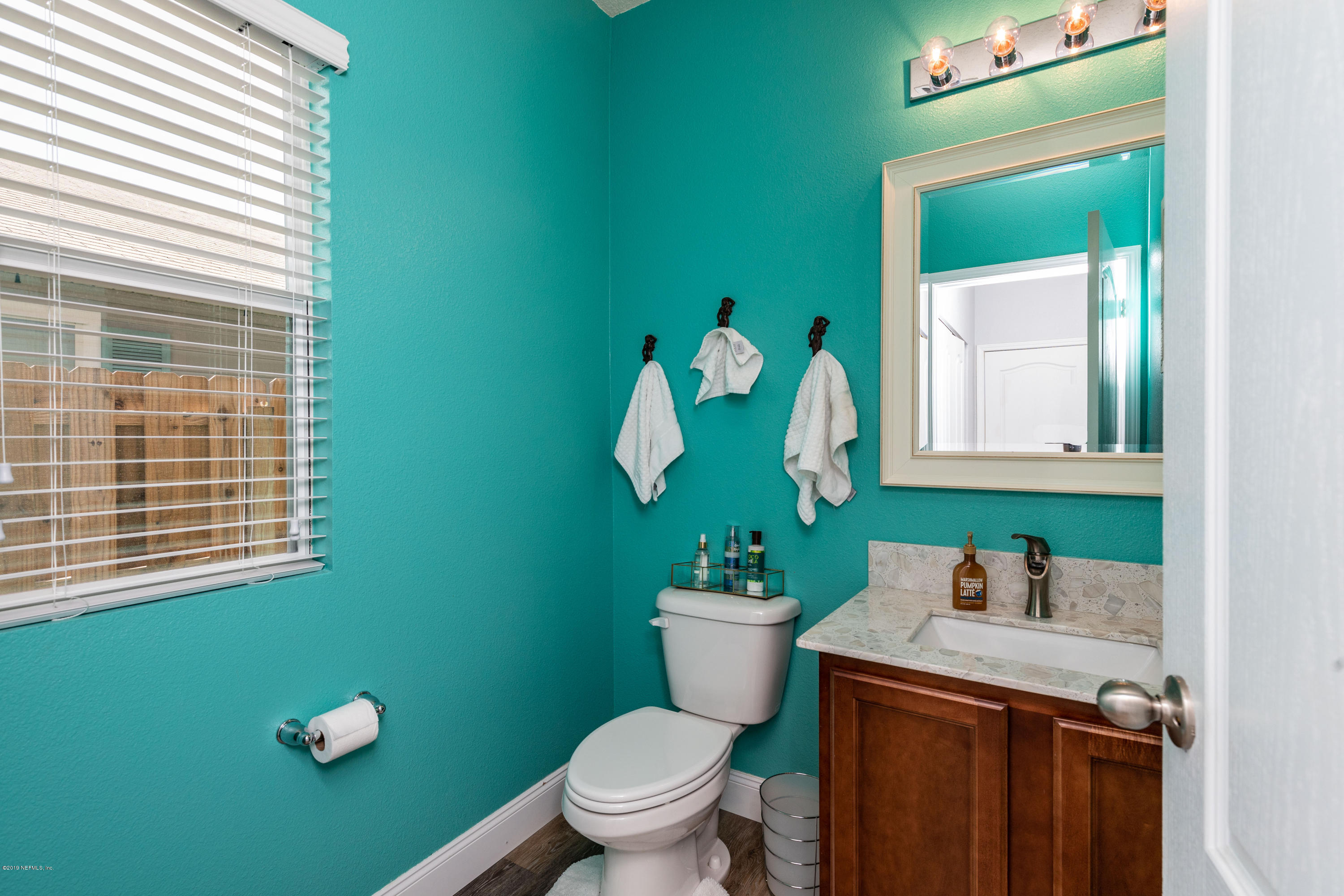 194 Ashby Landing Way St. Augustine, FL 32086 - Photo 20 of 41 a bathroom with a toilet sink and mirror