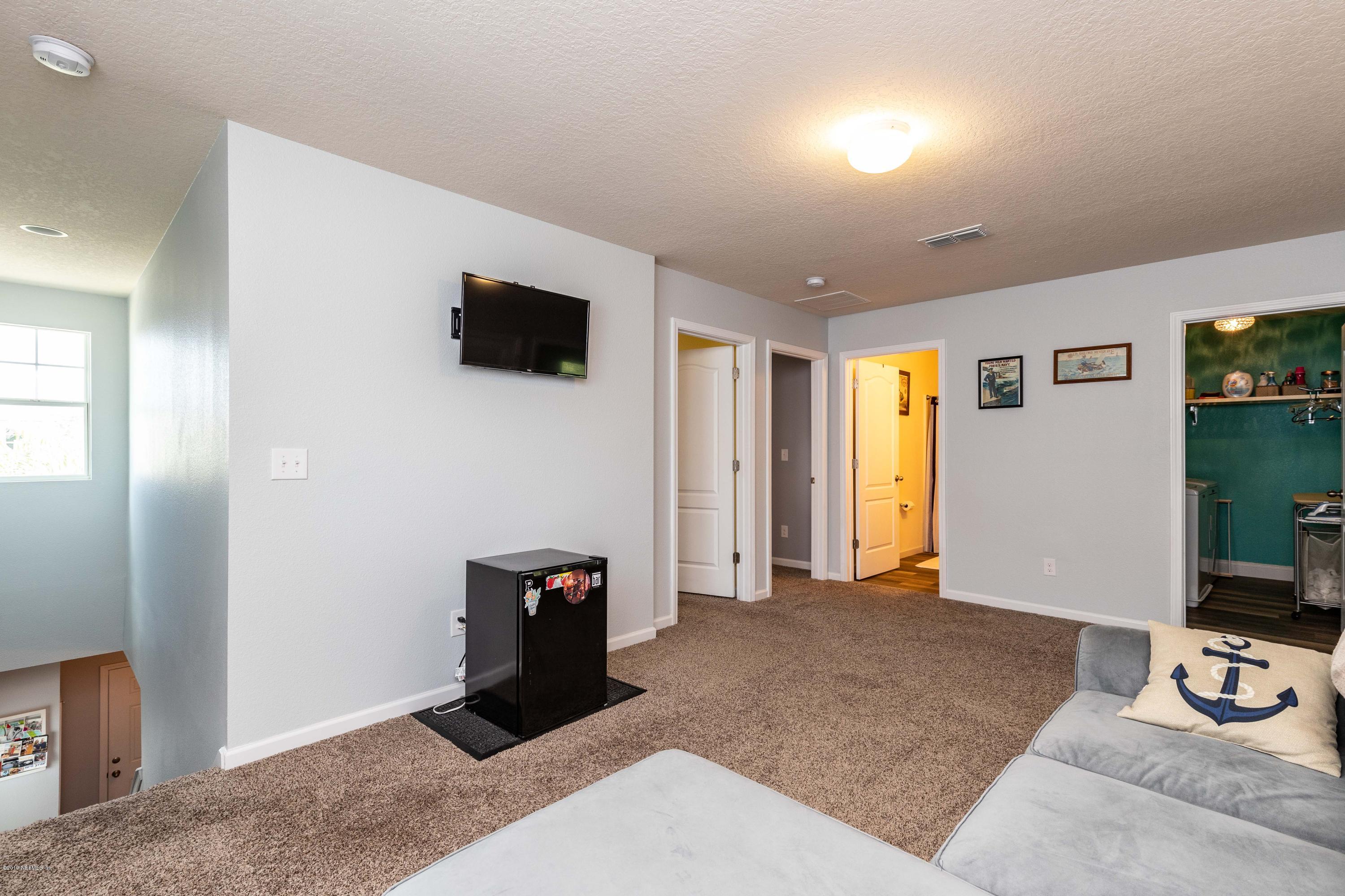 194 Ashby Landing Way St. Augustine, FL 32086 - Photo 22 of 41 a living room with furniture and a flat screen tv