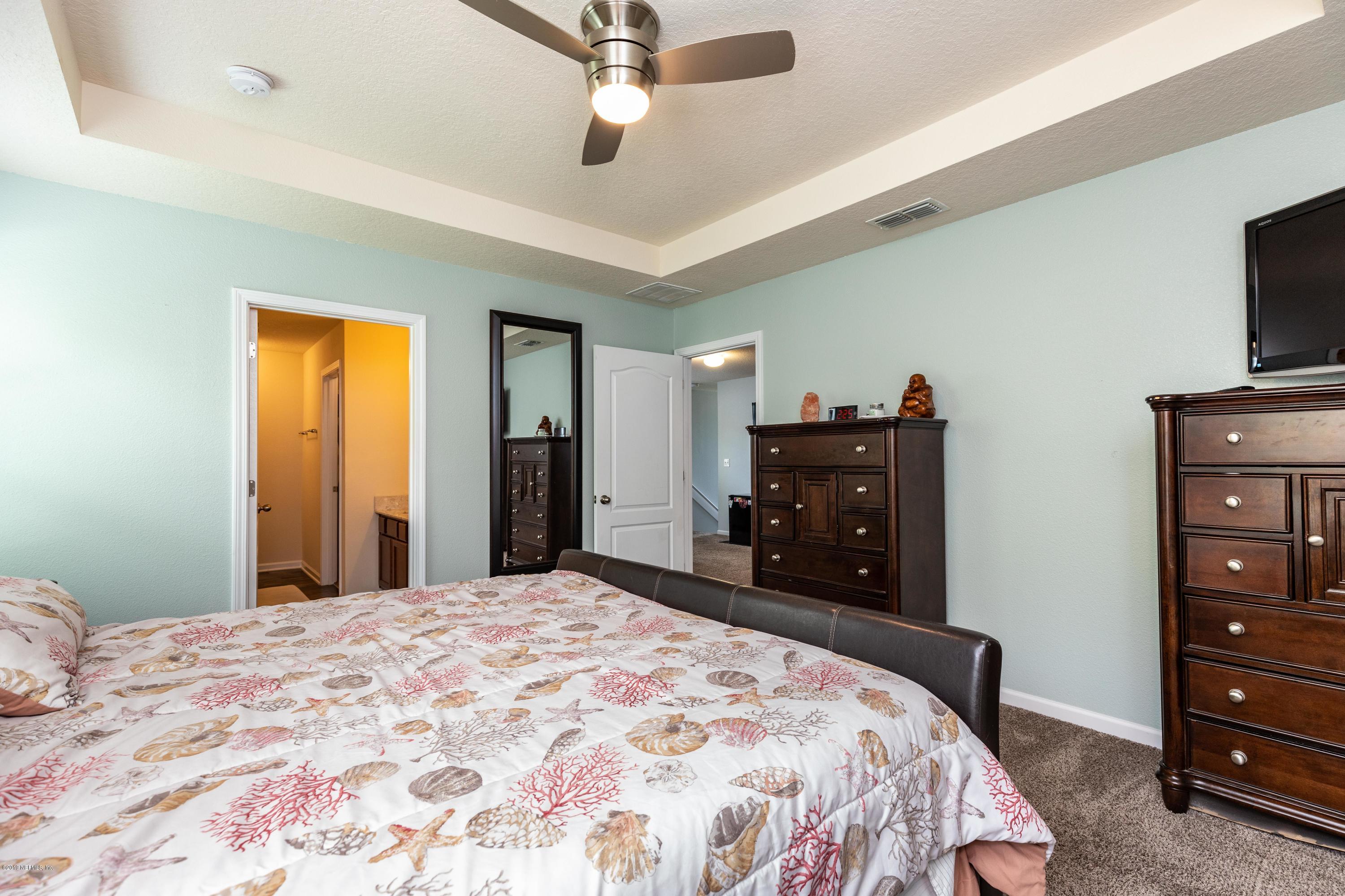 194 Ashby Landing Way St. Augustine, FL 32086 - Photo 26 of 41 a bedroom with a bed and a television