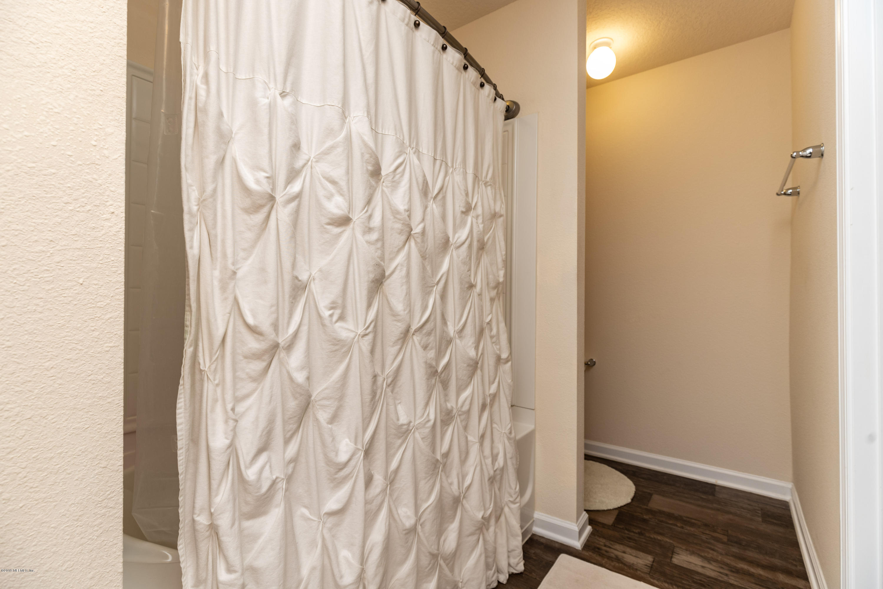 194 Ashby Landing Way St. Augustine, FL 32086 - Photo 28 of 41 a bathroom with a toilet and shower curtain