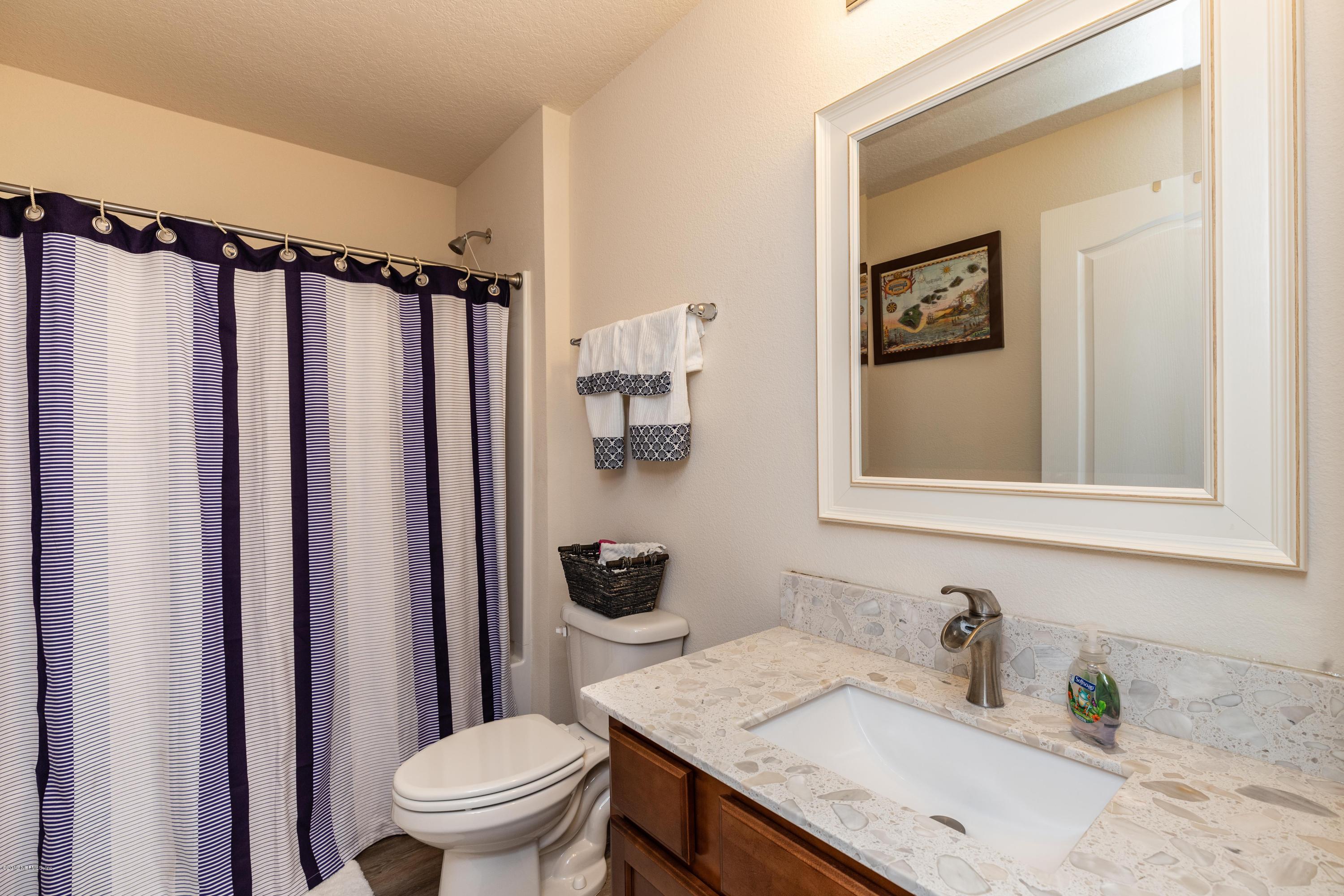 194 Ashby Landing Way St. Augustine, FL 32086 - Photo 31 of 41 a bathroom with a granite countertop sink toilet and shower