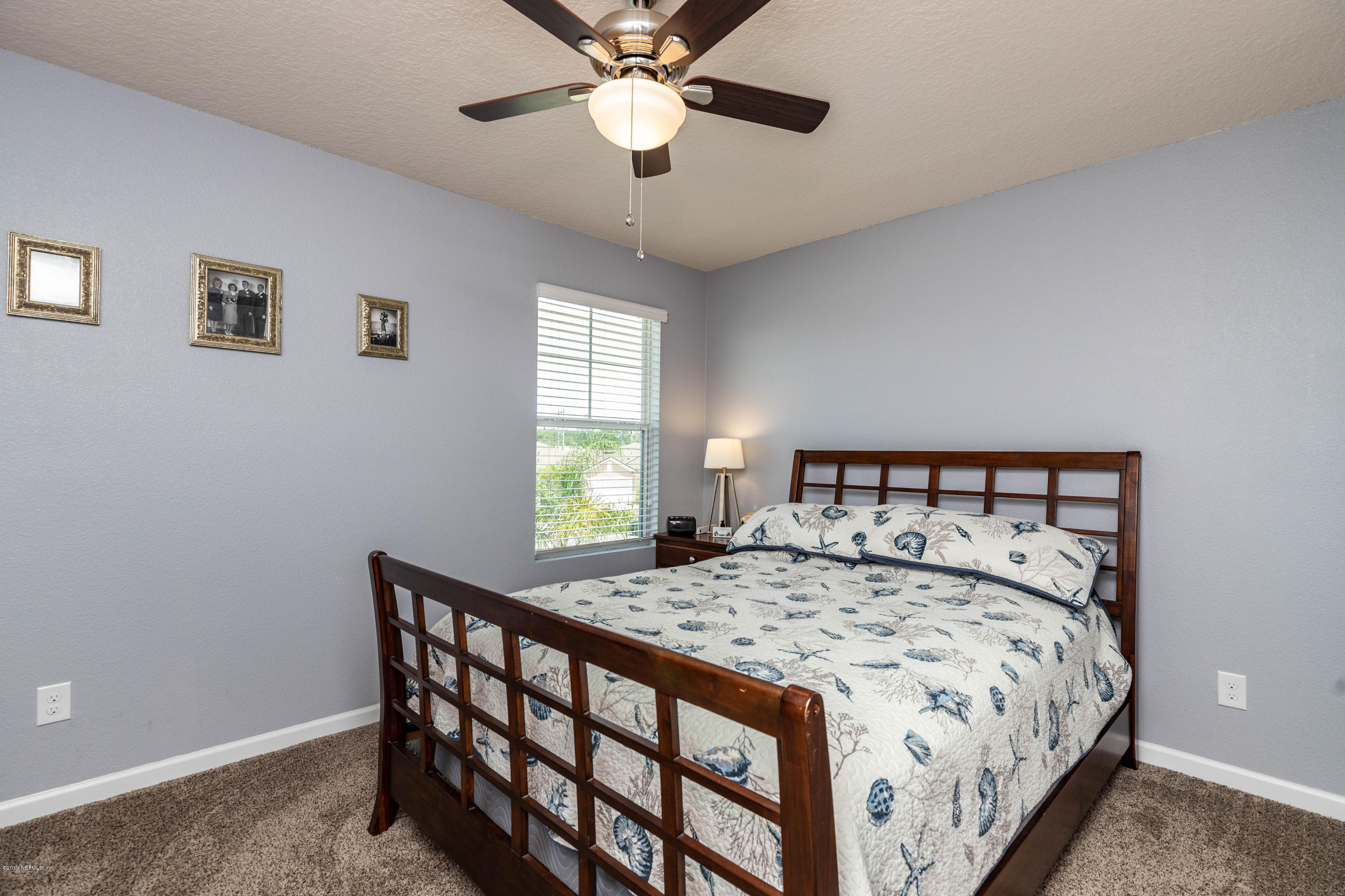 194 Ashby Landing Way St. Augustine, FL 32086 - Photo 33 of 41 a bedroom with a bed and a chandelier