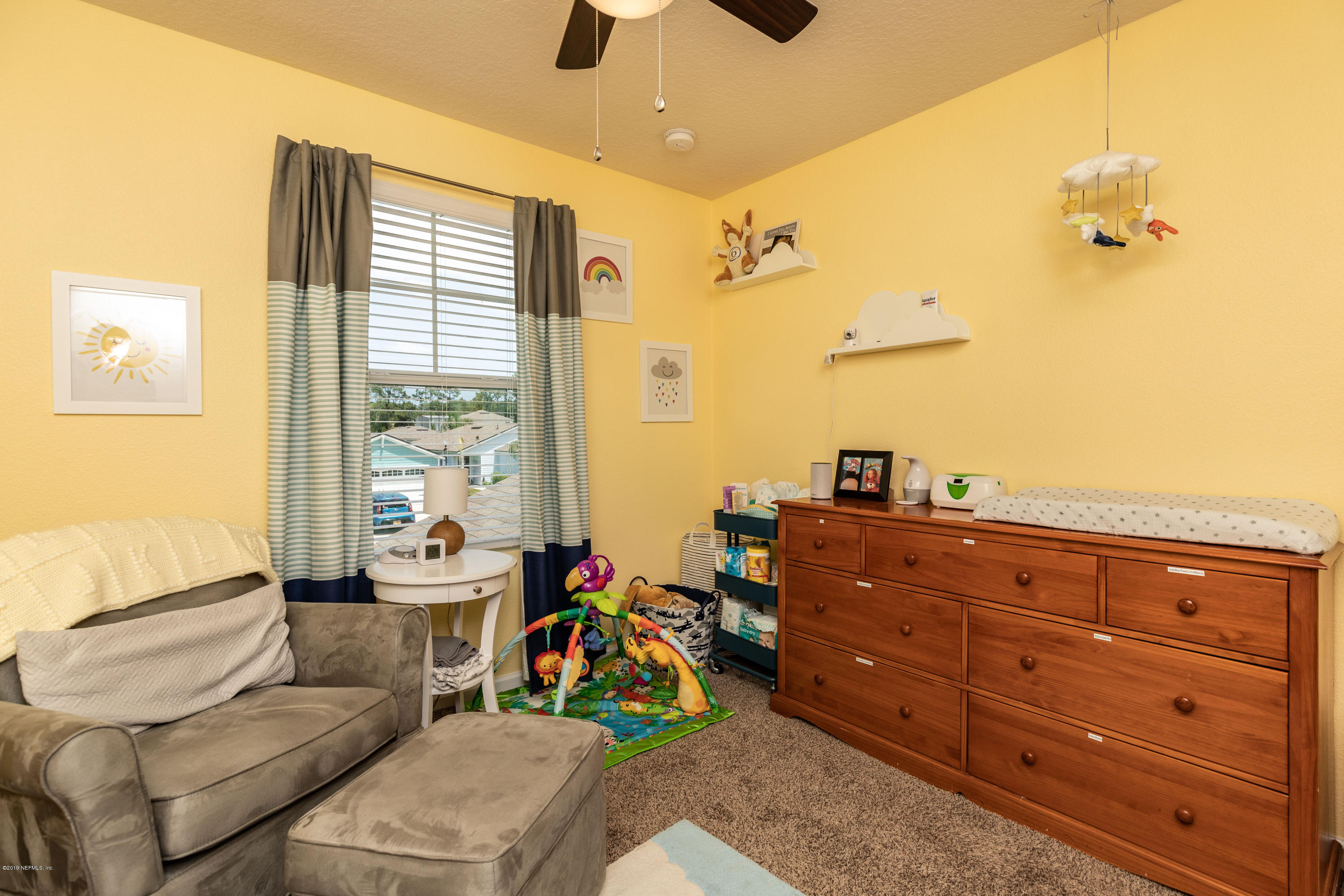194 Ashby Landing Way St. Augustine, FL 32086 - Photo 34 of 41 a living room with couches dresser and a chandelier