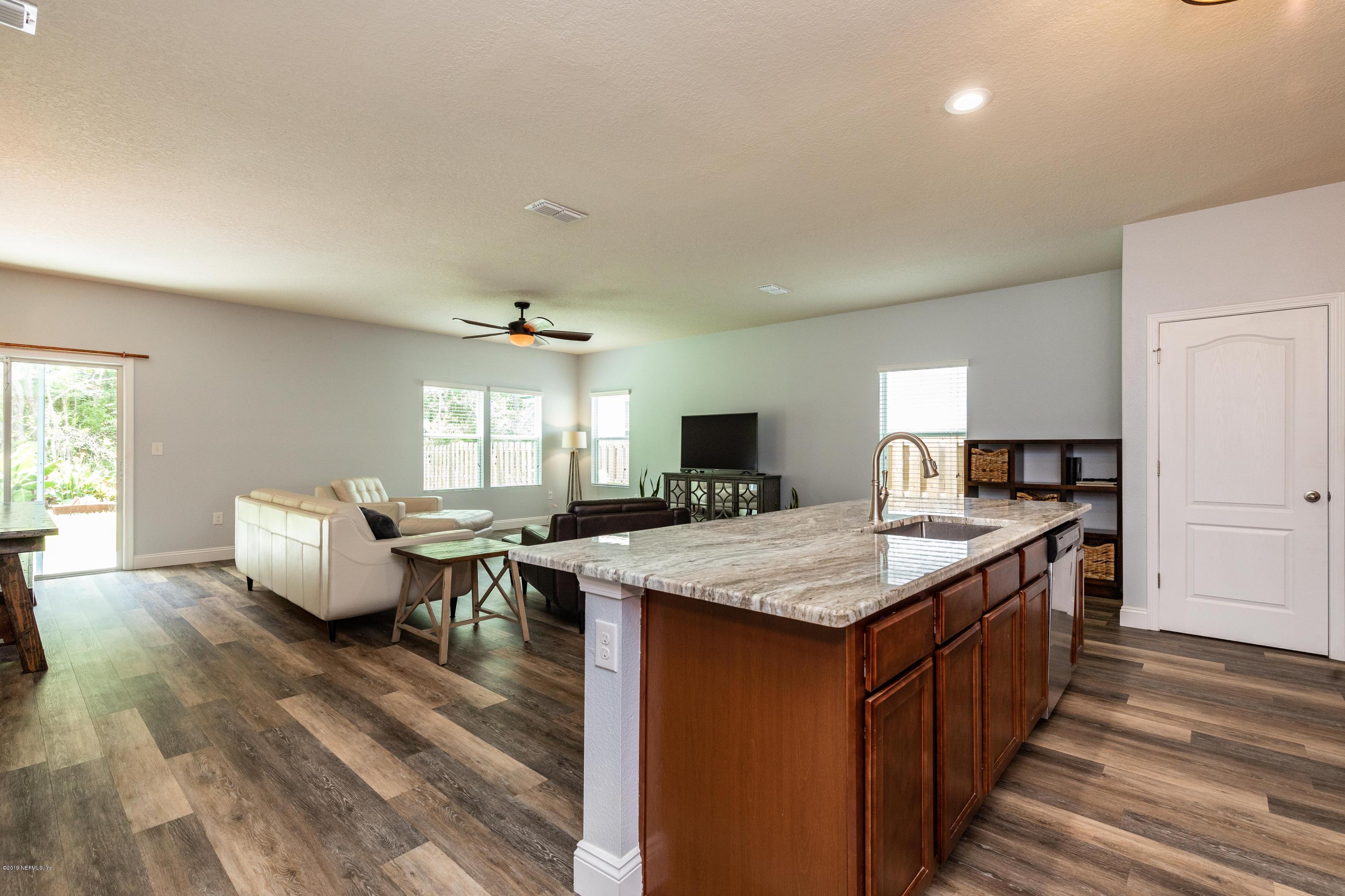 194 Ashby Landing Way St. Augustine, FL 32086 - Photo 8 of 41 a kitchen with counter top space and living room