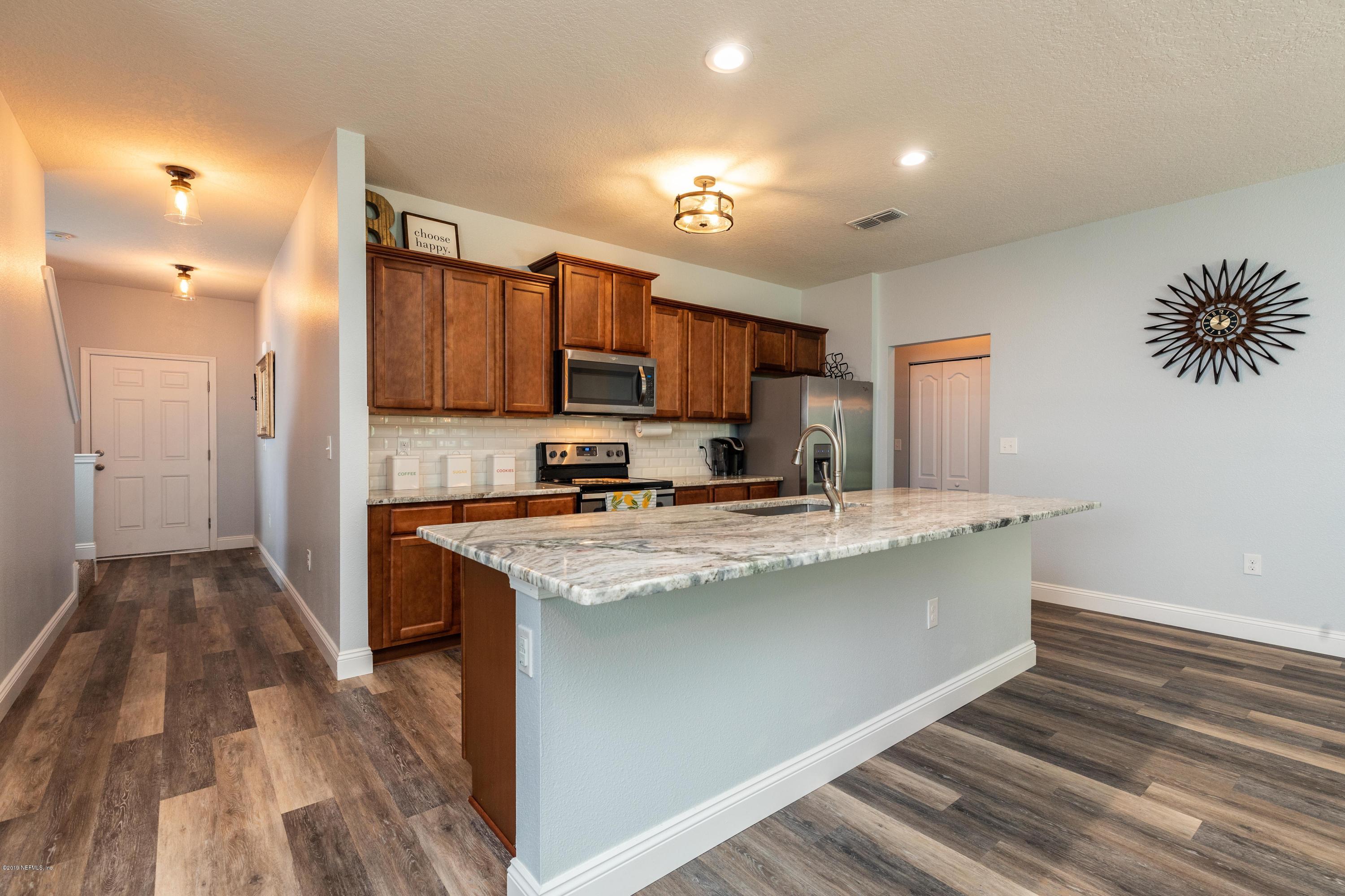 194 Ashby Landing Way St. Augustine, FL 32086 - Photo 9 of 41 a kitchen with stainless steel appliances granite countertop a sink a stove and a refrigerator