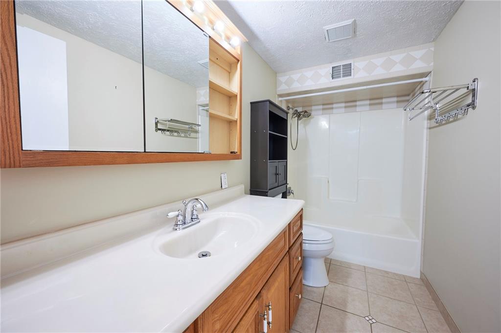 1205 Dutilh Road, Unit 4 Cranberry Township, PA 16066 - Photo 17 of 25 a bathroom with a sink a toilet and shower