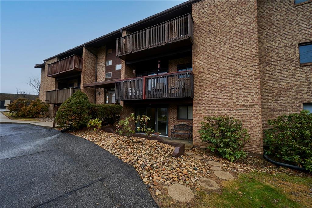 1205 Dutilh Road, Unit 4 Cranberry Township, PA 16066 - Photo 3 of 25 a front view of a house with yard and seating area