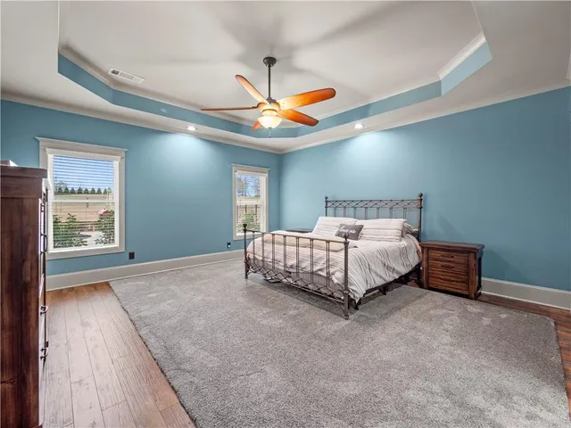 a bed sitting in a room next to a window