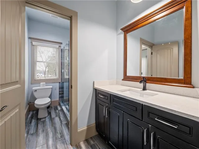 a view of a livingroom with wooden floor and a ceiling fan