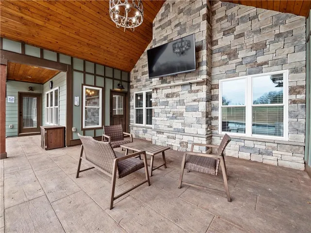 a view of a house with backyard porch and sitting area