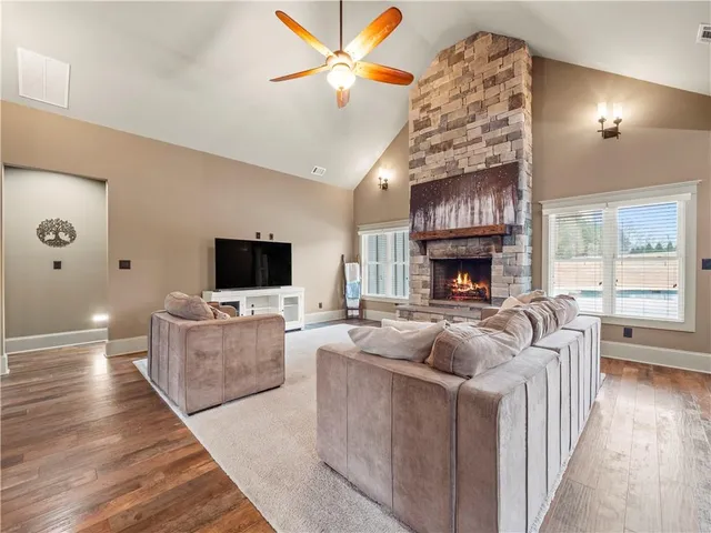a living room with furniture a fireplace and a flat screen tv