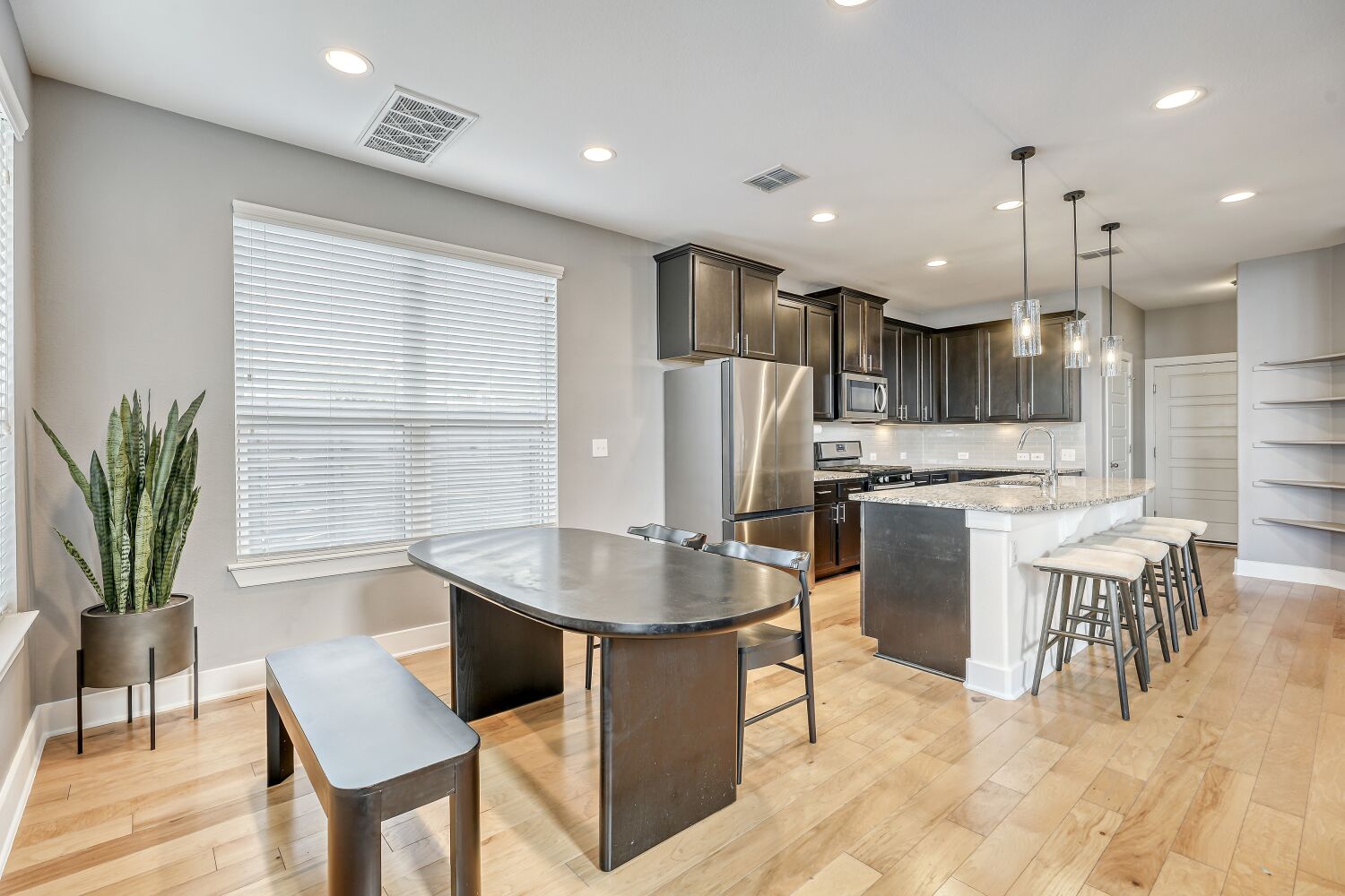 7406 Oberon Street, Unit 69 Austin, TX 78741 - Photo 5 of 16 Kitchen features granite countertops, a kitchen island with bar seating, SS appliances (fridge will convey), and gas range.