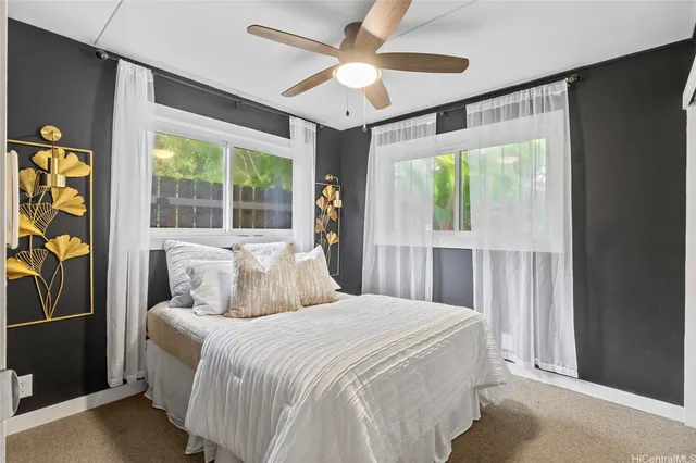 a bedroom with a large bed and a large window