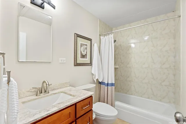 a bathroom with a granite countertop sink a toilet and shower