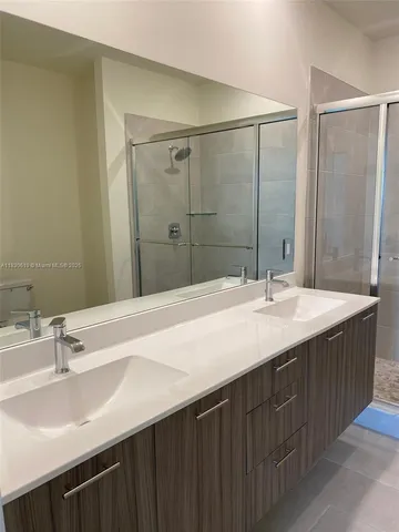 a bathroom with a sink double vanity and a mirror