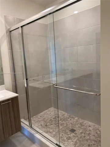 a bathroom with a glass shower door
