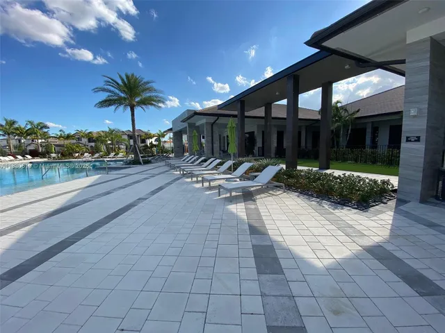 a view of a patio with swimming pool table and chairs