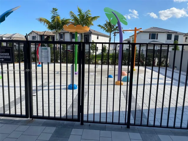 a view of a brick house with a small yard and plants