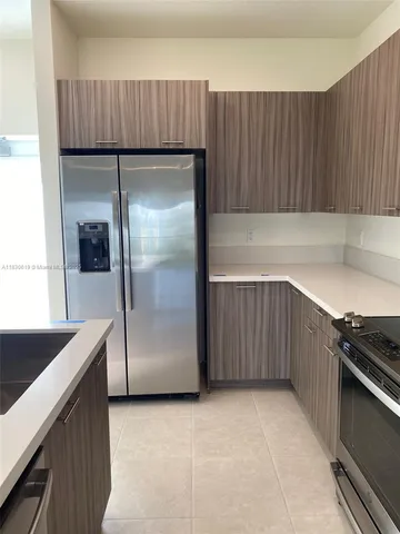 a kitchen with a refrigerator and a cabinets