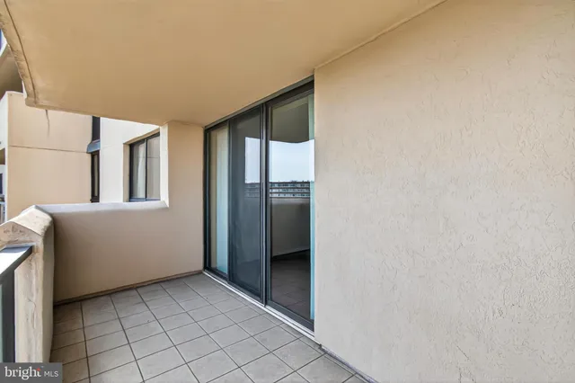 an empty room with wooden floor and window