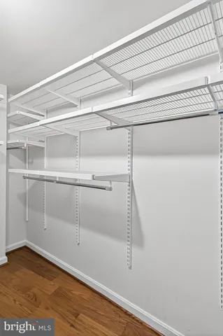 a view of walk in closet with empty racks