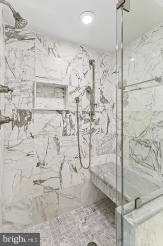 a bathroom with a sink toilet vanity and shower