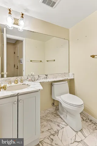 a bathroom with a sink vanity and a mirror