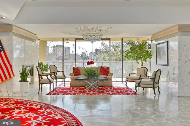 a living room with patio furniture and a floor to ceiling window