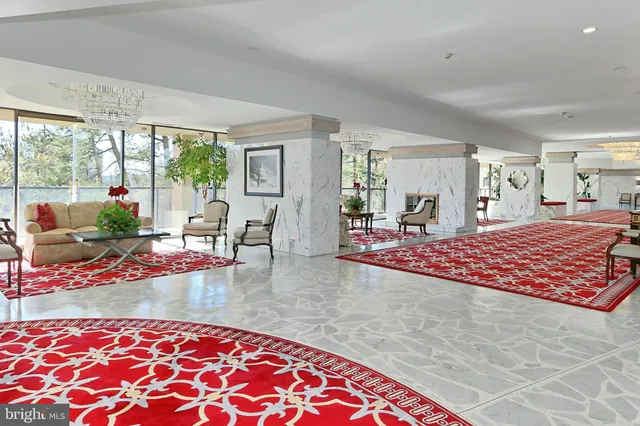a bedroom with furniture and a large window